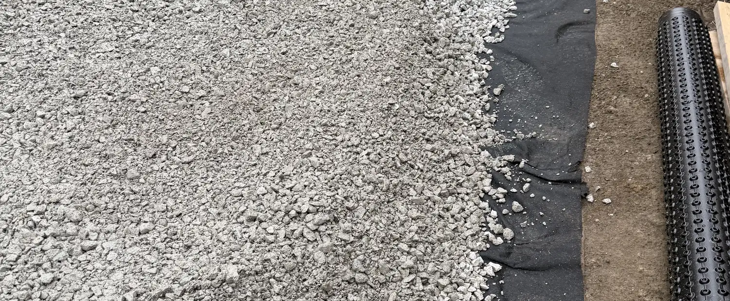 Geotextile laid under a compacted gravel base on a Toronto job site